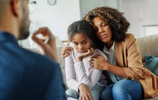 Mother and child in emotional discussion with advisor, representing child custody modification after divorce and decisions based on the child’s best interests